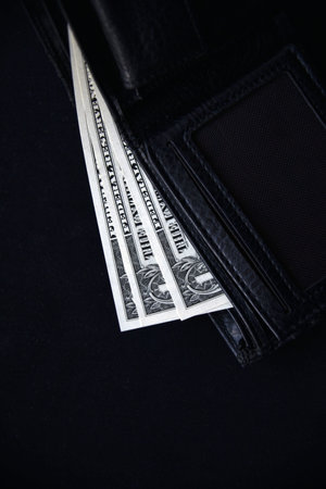 Dollar bills and rubles from a black wallet