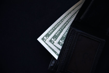 Dollar bills and rubles from a black wallet