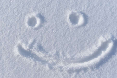 A smiling face in the snow in winterの写真素材