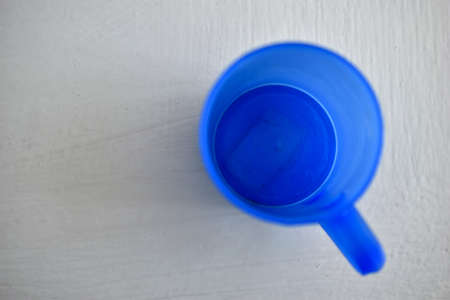 Blue plastic mug on a white backgroundの写真素材
