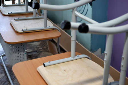 Chairs and desks in the classroomの写真素材