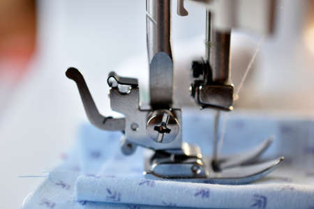 New White sewing machine with threads at homeの写真素材