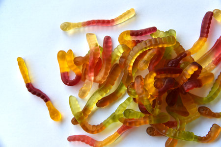 Colorful delicious marmalade worms on a plate