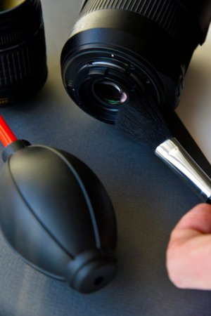 Cleaning photo lenses with a brush and a pear