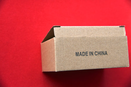 Cardboard box with the inscription made in China on a red backgroundの写真素材