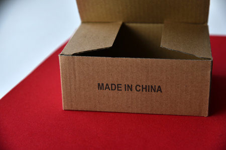 Cardboard box with the inscription made in China on a red backgroundの写真素材