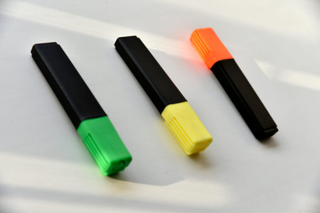 Colored markers on a white background in the light