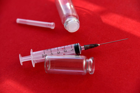 Medical syringe tablets and glass bubbles on a red background