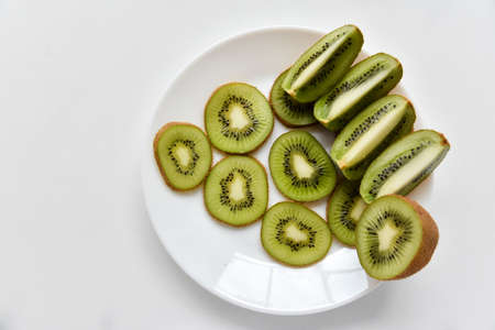 Kiwi fruit sliced on a white plateの写真素材