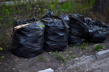 Black garbage bags after street cleaning