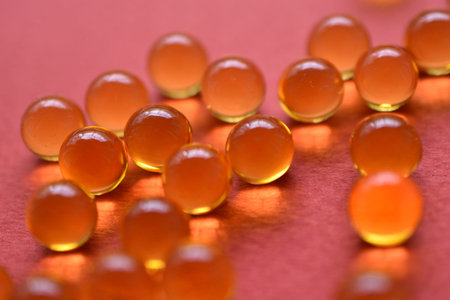 Yellow balls with yellow liquid on a red background. Glass yellow balls.