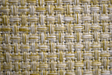 Yellow carpet fabric background close-up with threads