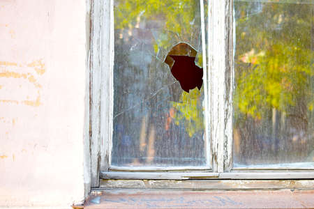 The window in the house is broken glass hooliganism.の写真素材