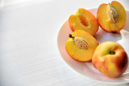 Sliced peaches and nectarines on a white plate
