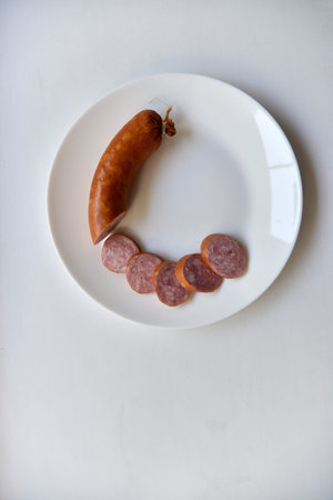 Delicious meat sausage on a white plate