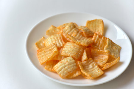 Delicious potato chips with pepper on a white plate. Vegetarian food. fast food.