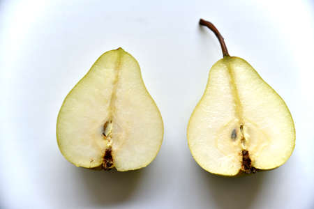 Sliced green pear in half on a white background. nature background.の写真素材