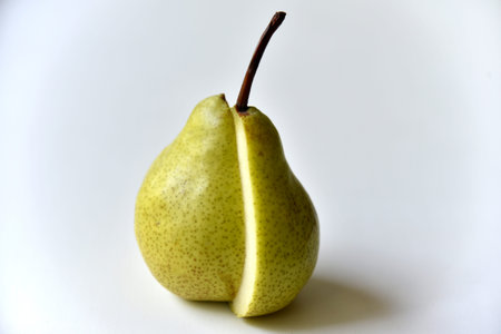 Sliced green pear in half on a white background. nature background.の写真素材