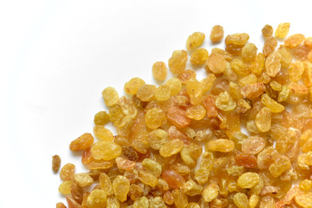 Yellow juicy raisins on a white background. Vegetarian food. isolated object.の写真素材