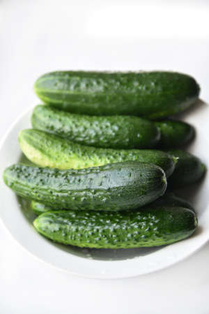 Green juicy cucumbers on a white background. healthy lifestyle. isolated object.の写真素材