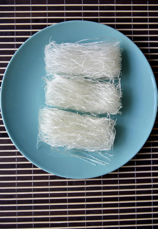 Dry rice noodles for cooking Korean dishes. Asian food. top view. Vegetarian food.