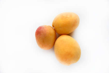 Yellow juicy fresh plum on a white background. Juicy yellow sweet fruits. Vegetarian food.の写真素材