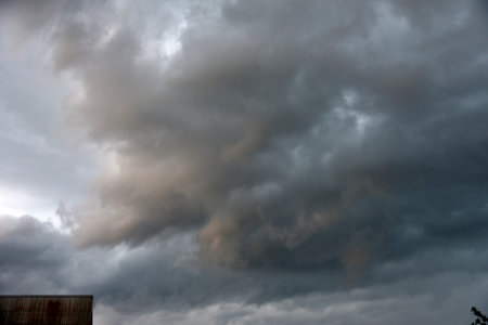 Black thunderstorm storm clouds on the horizon on a summer day. weather background.の写真素材