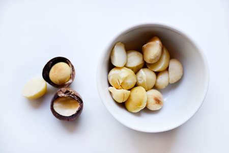 Whole nut and Macadamia kernel on a white background. Delicious whole nuts. natural background. healthy meals.の写真素材