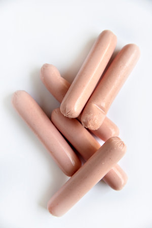 Juicy meat sausages in a group on a white background. Delicious sausages for breakfast.の写真素材
