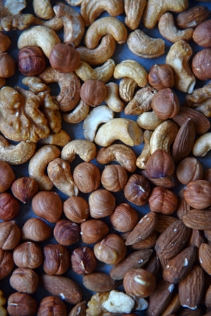 Various delicious nuts on the playground. Nut mixture as a delicious breakfast. Vegetarian food.の写真素材