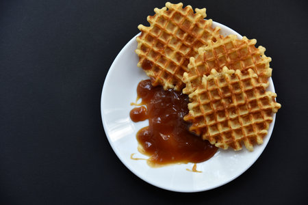 Delicious Viennese waffles with jam on a white plate. A sweet breakfast of Viennese waffles.Healthy eating.の写真素材