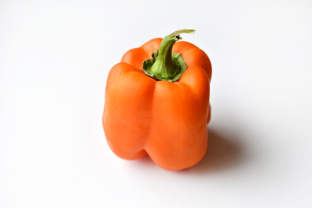 Orange large pepper fruit on a white background. Beautiful ripe pepper close-up. natural background.の写真素材