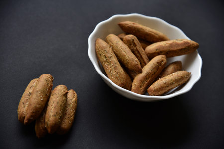 A small spicy cookie in the form of buns on a plate. Cookies close-up. top view.