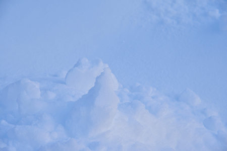 Snow surface with lumps and snowdrifts in winter. Winter snow field surface.Sunlight background....