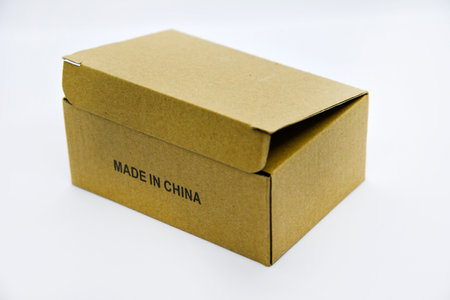 Cardboard box with the inscription made in China. A box on a white background. A small box made in China on a white background.の写真素材