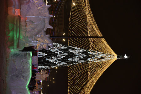 Chelyabinsk, Ural Russia - 01 03 2023: New Year's Square in the center of Chelyabinsk and an ice town with sculptures. Christmas lights in the night city.のeditorial素材