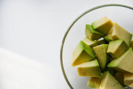 Avocado cut into small slices. avocado salad. Peeled avocado on a plate.の写真素材
