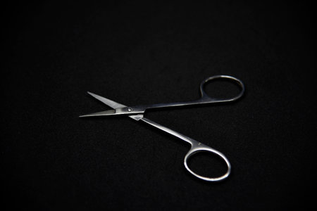Manicure set on a black background. Scissors and nail tongs. Iron scissors and nail clippers.の写真素材