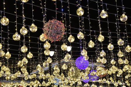 Beautiful and bright LED illuminations on the street. Hanging garlands of LED lamps. Large lamps.の写真素材