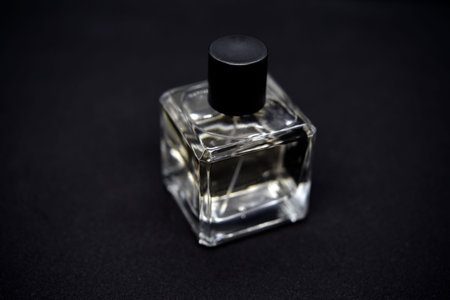 A glass perfume bottle on a black background. A bottle of perfume in close-up. Perfume.の写真素材