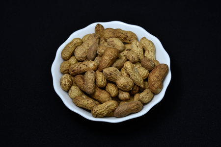 groundnut. Unpeeled peanuts in a white plate. Peanuts in the peel.