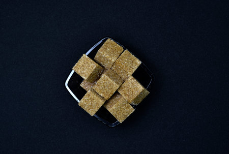 Pieces of cane sugar in a bowl. Refined sugar. Sugar in chunks in a cup.の写真素材