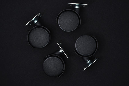 Top view of a group of black speakers on a black background.