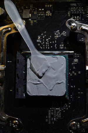 Close up of a computer processor with a screwdriver on it.