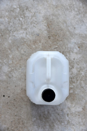 White plastic large canister. An empty plastic canister.