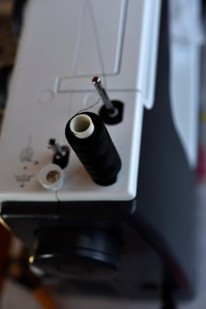 A white sewing machine in the room. Processing of clothes with a sewing machine.の写真素材