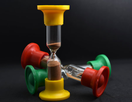 Hourglass on black background, close-up. time management conceptの写真素材