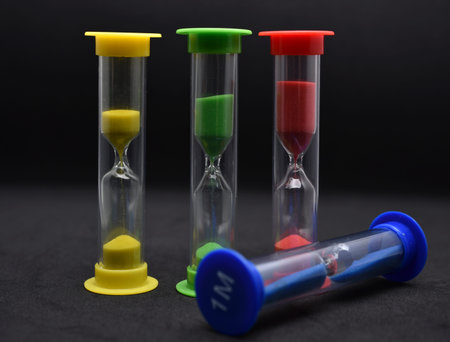 Hourglass on black background. Time management concept. selective focus.