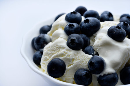 Ice cream with berries. Ice cream in a ceramic bowl. Ice cream and blueberries.