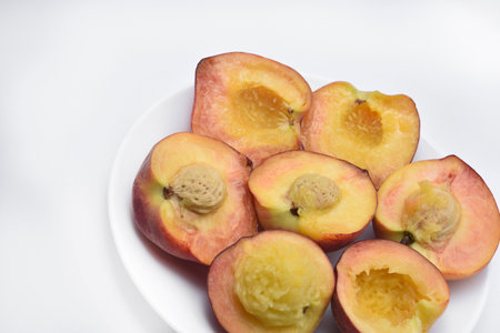 Peaches on a white plate isolated on white background. Healthy food concept.の写真素材